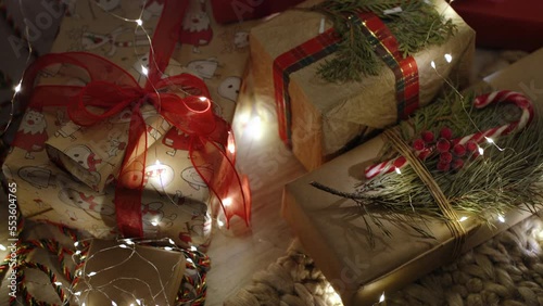 Many gift boxes and christmas decorations under a beautiful decorated christmas tree with bokeh lights in living room at night.Concept of Merry Christmas, New Year at home. photo