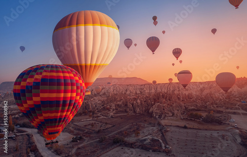 Colorful hot air balloons fly, Amazing sunrise Cappadocia, Goreme national park. Turkey travel Concept, aerial view