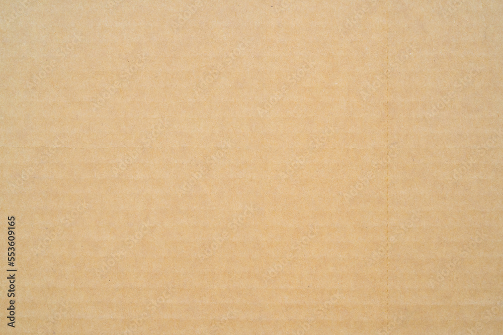 smooth brown cardboard paper, full frame, close up. background and texture of brown paper corrugated sheet board surface smooth brown cardboard paper, full frame, close up. background and texture of brown paper corrugated sheet board surface