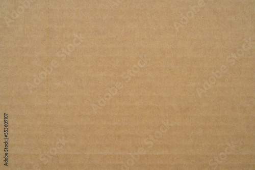 smooth brown cardboard paper, full frame, close up. background and texture of brown paper corrugated sheet board surface © Zhanna