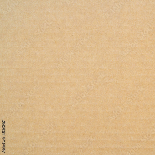 smooth brown cardboard paper, full frame, close up. background and texture of brown paper corrugated sheet board surface