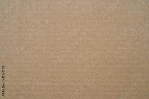 smooth brown cardboard paper, full frame, close up. background and texture of brown paper corrugated sheet board surface