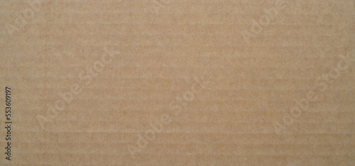 smooth brown cardboard paper, full frame, close up. background and texture of brown paper corrugated sheet board surface © Zhanna