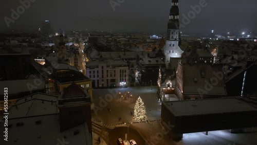 Magical winter night over Riga old town in Latvia during New Years time. Cozy little Christmas market with amazing Christmas tree in the middle of the city.