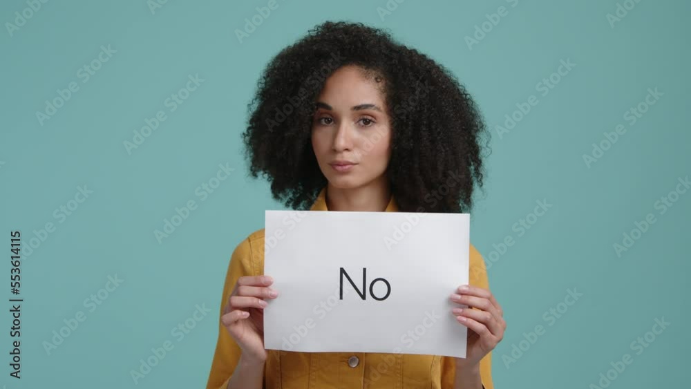 Portrait of a woman looking concerned and serious. Woman holding white card with negative expression and shaking her head. High quality 4k footage Portrait of a woman looking concerned and serious. Woman holding white card with negative expression and shaking her head. High quality 4k footage