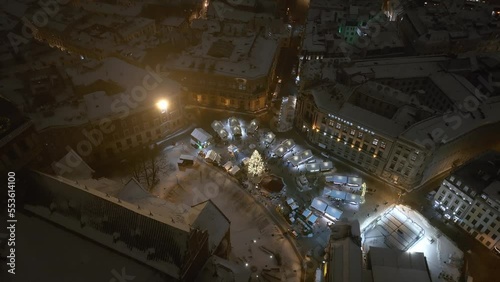 Magical winter night over Riga old town in Latvia during New Years time. Cozy little Christmas market with amazing Christmas tree in the middle of the city.