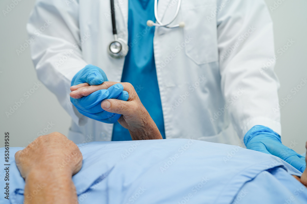 Doctor holding hands Asian elderly woman patient, help and care in hospital. Doctor holding hands Asian elderly woman patient, help and care in hospital.