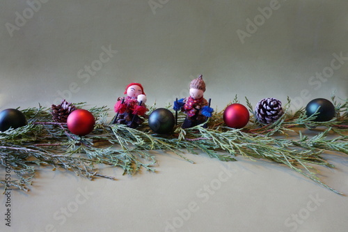 Greenery, Red and Green Christmas Balls, Skier Ornaments Made from Pinecones on Green Background, Horizaontal photo