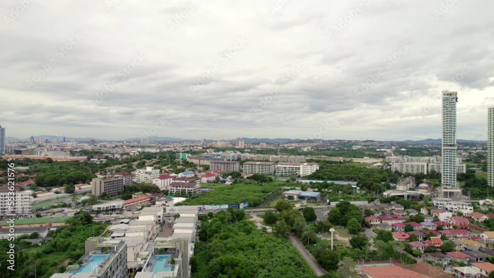 Moving across Pattaya city during daytime. Drone shot of suburb area in Thailand. Aerial city view on a cloudy day Moving across Pattaya city during daytime. Drone shot of suburb area in Thailand. Aerial city view on a cloudy day