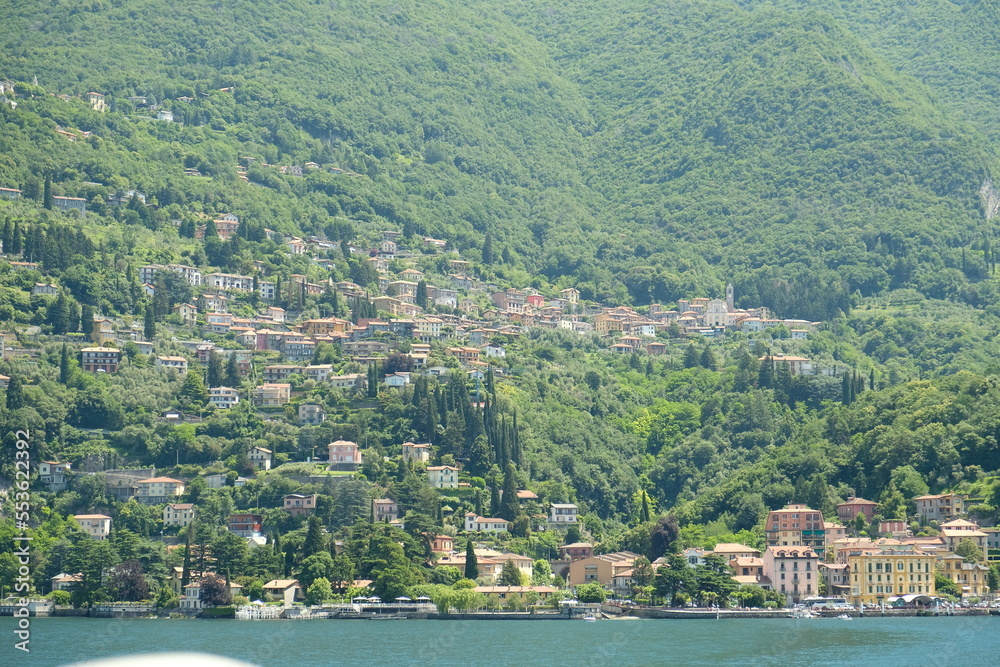 Como Lake landscape. Cernobbio village, trees, water and mountains. Italy, Europe.