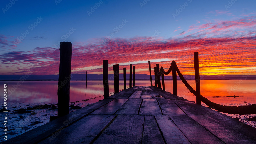 Fototapeta premium Sunrise of a wooden pier
