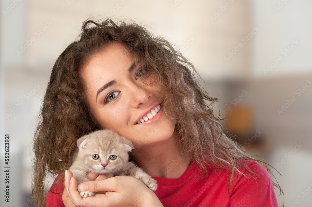 Happy young woman with small cute cat Happy young woman with small cute cat