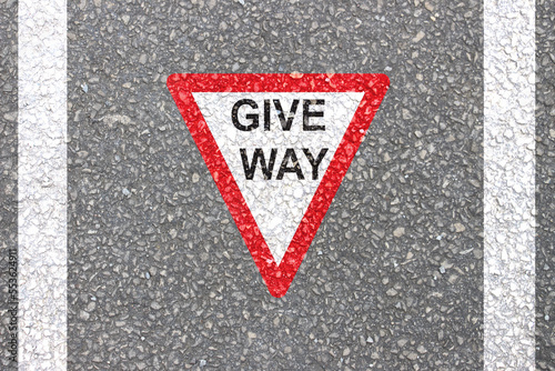 Give Way Traingle symbol painted on road is Sameer sign for movement of vehicles.