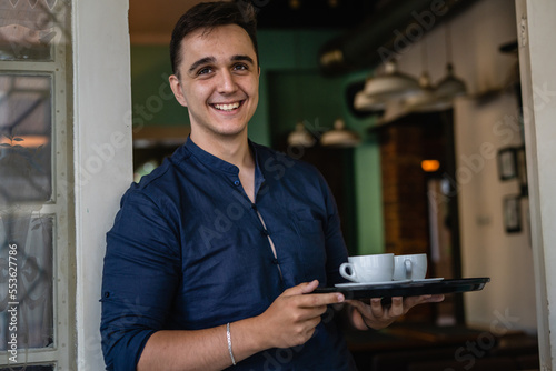 caucasian man take two cups of coffee happy smile waiter