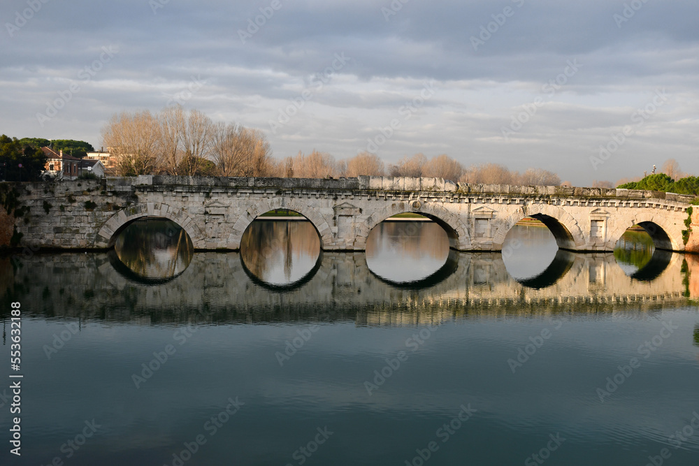 Tiberius Bridge in Rimini, Italy, and its reflection in the Marecchia river