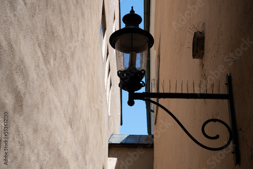 Street light attached to a wall in the old town of Passau, Germany