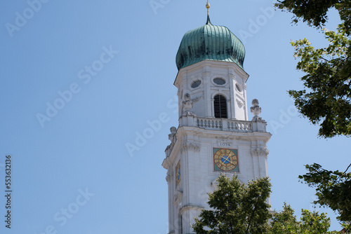 Tower of the 17th-century Dom St. Stephan (St. Stephen's Cathedral) in Passau, Germany, seen against a blue sky on a sunny day