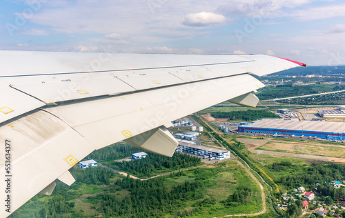 View from the airplane window during taking off on a clear summer morning. Yekaterinburg, Russia