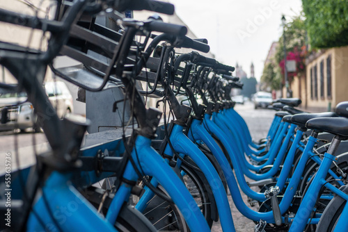 Canvas Print Row of bicycles on the docking station, public bike-sharing mobility system