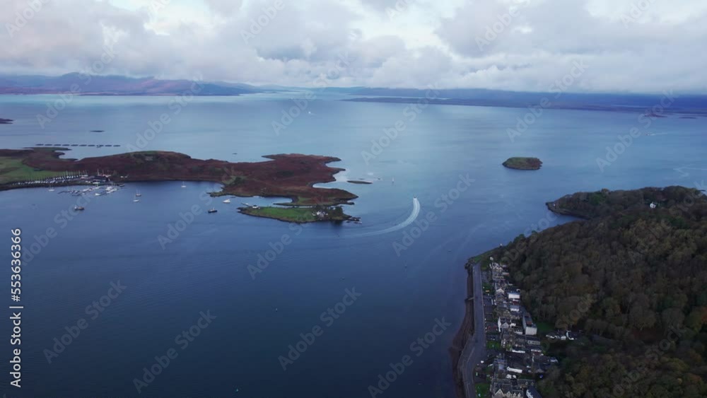 Aerial View of Boat Sailing Out of Oban Bay, Scotland UK, Scenic Coastline and Seascape Aerial View of Boat Sailing Out of Oban Bay, Scotland UK, Scenic Coastline and Seascape
