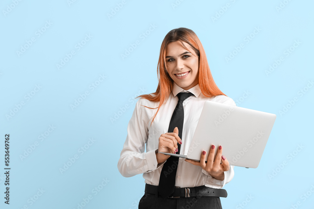Beautiful transgender secretary with laptop on blue background Beautiful transgender secretary with laptop on blue background