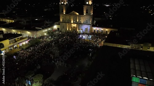 Crowded Square Outside The Cathedral Of Tuxpan At Night. Celebration Of XXIV Meeting Of Ancestral Dances In Jalisco, Mexico. aerial tilt-up photo