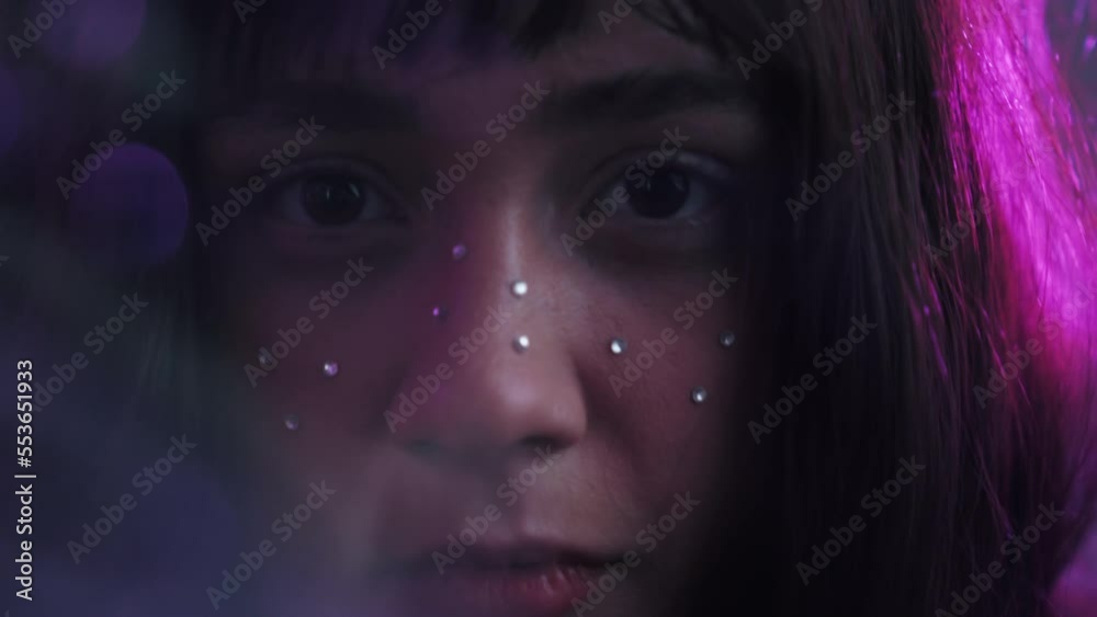Fierce-looking Female Model With Rhinestone Gems On Her Face. closeup, zoom-in Fierce-looking Female Model With Rhinestone Gems On Her Face. closeup, zoom-in