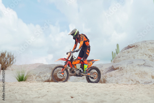 Young man practice riding dirt motorcycle. Splashing sand © VIAR PRO studio