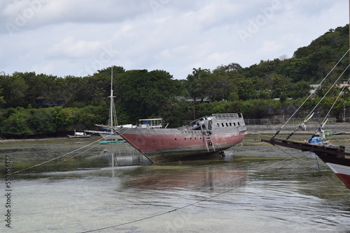 wooden fishing boat in the harbor, low tide