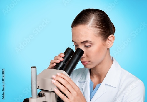 Young researcher work with microscope in lab.
