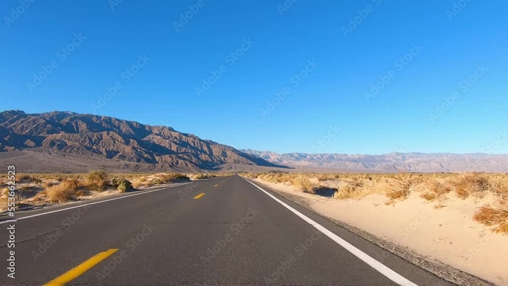 Driving long Straight Empty Road with a Mountain View in Death Valley National Park Driving long Straight Empty Road with a Mountain View in Death Valley National Park