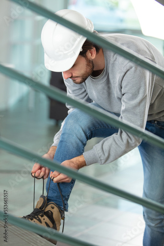 builder tying his laces shoes