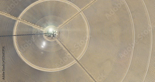 Solar thermal power plant. Renewable energy production. Solar energy. Aerial view of central power plant and industrial facilities surrounded by many reflecting mirrors. Sun moving. 3D rendering.