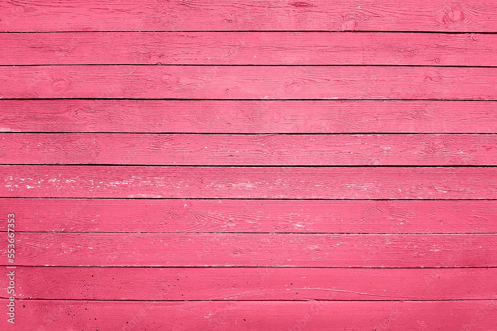Trendy color of the year 2023. Wooden planks boards, gorizontal pattern, toned in viva magenta color as background or texture Trendy color of the year 2023. Wooden planks boards, gorizontal pattern, toned in viva magenta color as background or texture