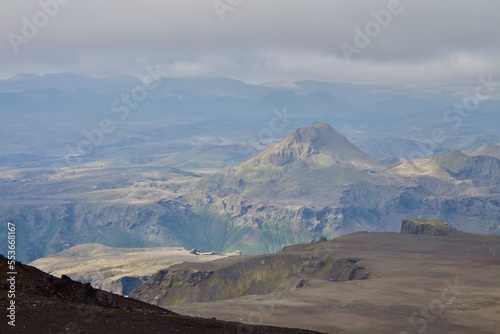 Majestic Icelandic Mountain landscape near fagradalsfjall volcano as seen from mountain peak with sunlight gently falling on the peaks. Earthy colours and authentic Icelandic nature.  