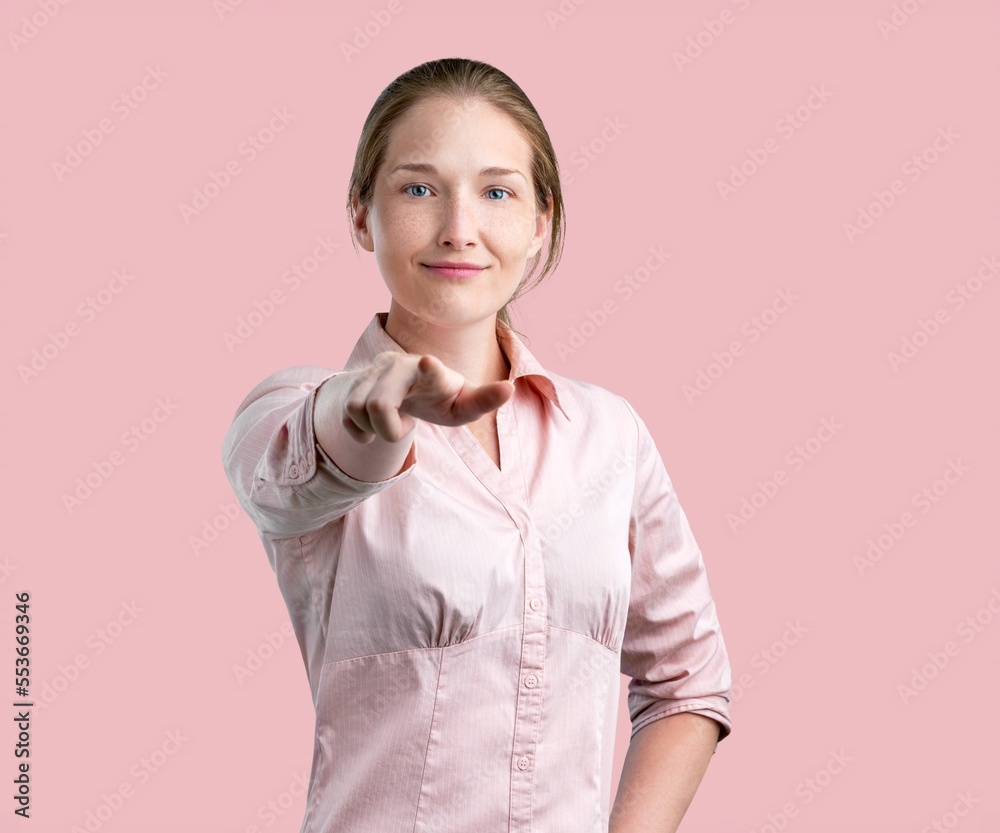 Young happy woman pointing fingers for you. Motivating concept. Young happy woman pointing fingers for you. Motivating concept.
