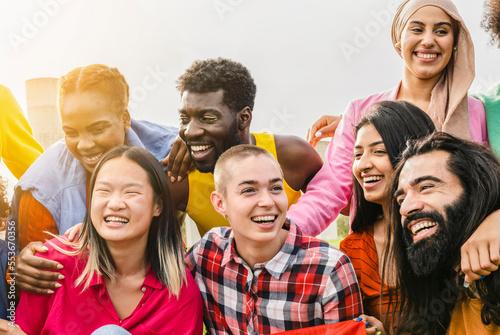 Diverse multi ethnic group of people having fun outdoors - non binary person, gender freedom -