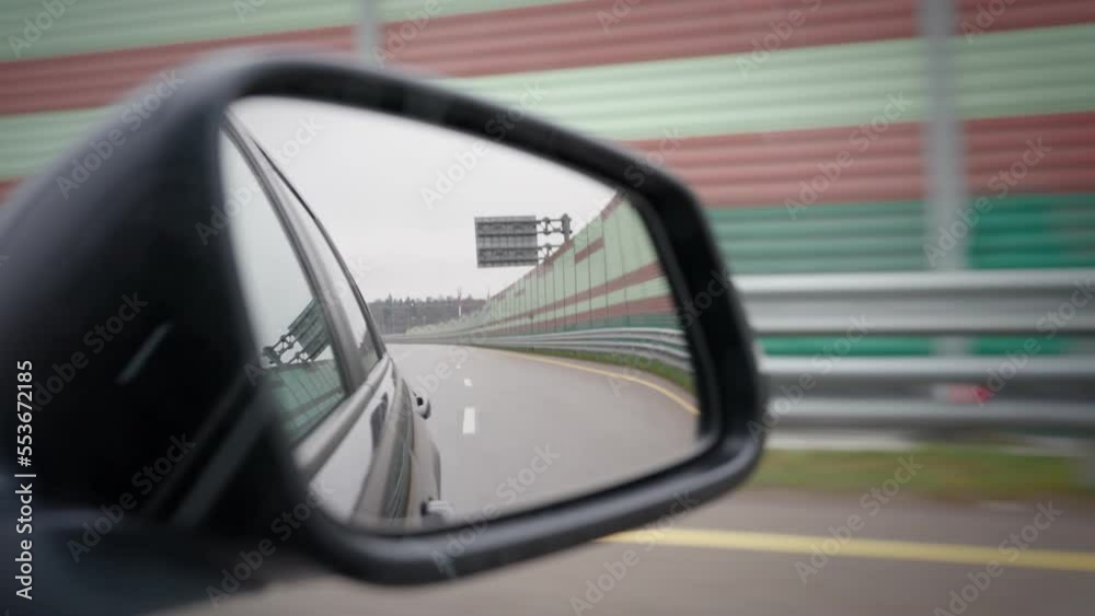 View of the side mirror of a moving car on the highway. View of the side mirror of a moving car on the highway.