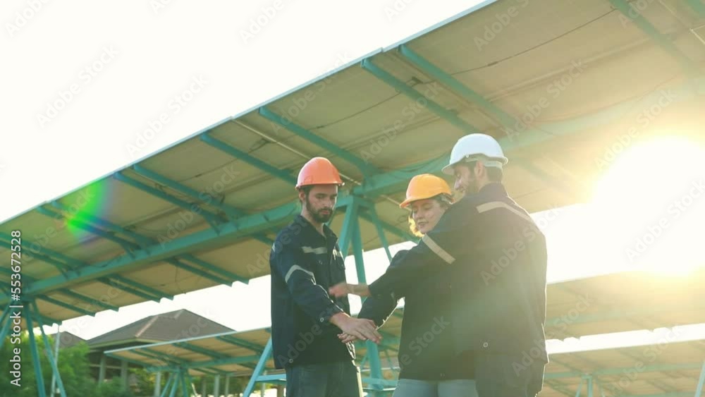 Team of electrical engineers men and women working in solar panel power station join hands and high five showing good standing at successful maintenance.
Team of electrical engineers men and women working in solar panel power station join hands and high five showing good standing at successful maintenance.