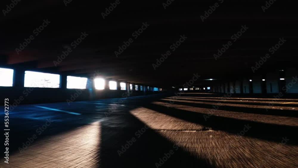 low angle pov driving through level 3 of covered parking garage building in chicago at sunset low angle pov driving through level 3 of covered parking garage building in chicago at sunset