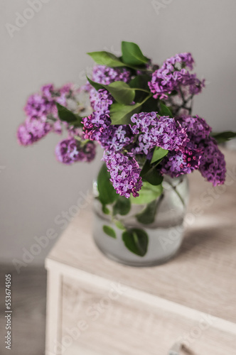 A bouquet of fresh lilacs in a glass vase.