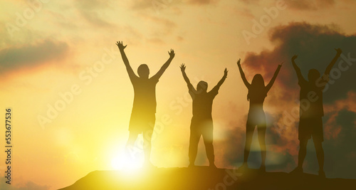 Silhouette family sports : Elderly parents and son daughter exercise, health care good health Raise your arms high, your mind is joyful and happy. exercise at sunset : happy family leisure activities.
