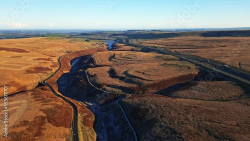 High Aerial Moorland View of Saddleworth moor, the M62 motorway and Ripponden road. Showing a wild landscape with busy traffic and snow lined moors. photo