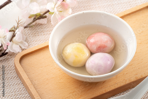 Colored glaze style big tangyuan with cherry blossom flower and syrup soup.