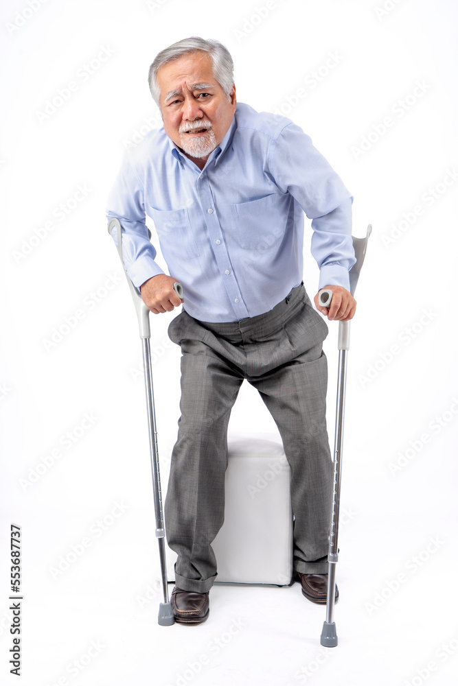 photos senior person with crutches on white background photos senior person with crutches on white background