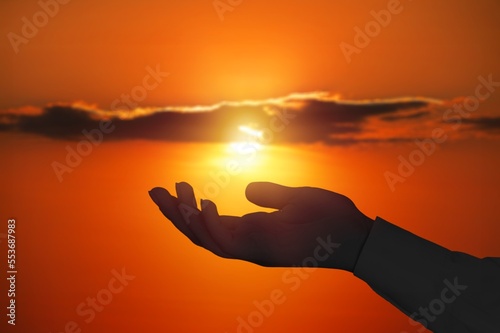 Silhouette of hand on beautiful sky background
