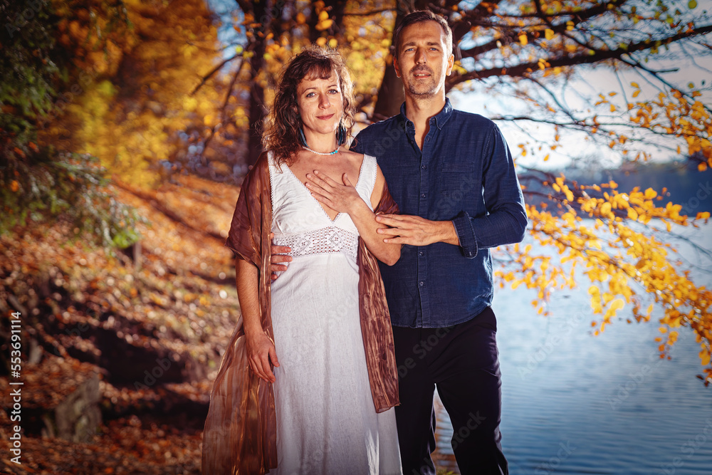 romantic couple in love by the lake in autumn. romantic couple in love by the lake in autumn.