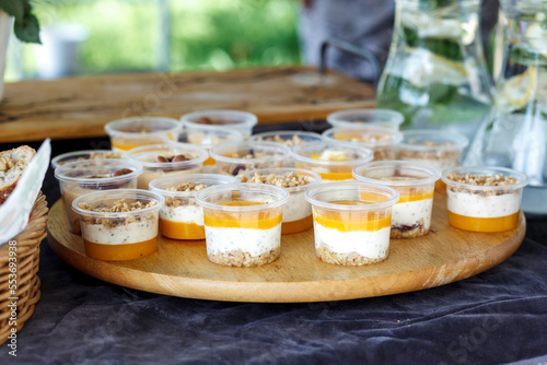 Mango dessert with cream and chia on a board.
