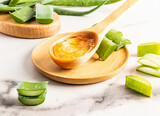 natural aloe vera gel in a wooden spoon among the slices of the plant. the concept of preparing a gel at home. rejuvenation of the skin of the face.