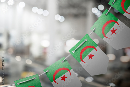 A garland of Algeria national flags on an abstract blurred background photo